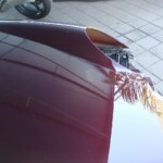 Before and after photographs of a damaged Porsche that was repaired by Elite Paint & Body Shop in West Palm Beach, Florida.
